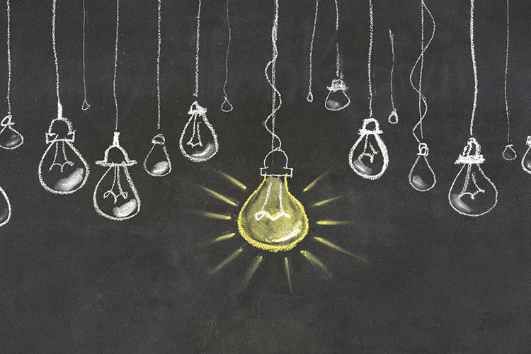 Illustration on a chalkboard of lightbulbs hanging.